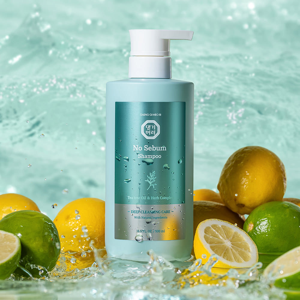ProtoClinical k-beauty [Daeng Gi Meo Ri] No Sebum Shampoo 500ml shown as a pale blue bottle close-up centered on a blue-green background with olive lower corners