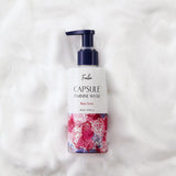 ProtoClinical k-beauty Foellie Capsule Feminine Wash 200ml #Bijou Scent close-up of a navy pump bottle with a clear gel droplet on a pale pink background