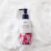 ProtoClinical k-beauty Foellie Capsule Feminine Wash 200ml #Bijou Scent close-up of a navy pump bottle with a clear gel droplet on a pale pink background