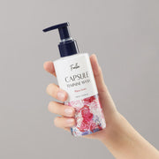 ProtoClinical k-beauty Foellie Capsule Feminine Wash 200ml #Bijou Scent upright feminine wash bottle on a blush pink background with clear liquid spill and glossy spheres
