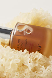 ProtoClinical k-beauty warm brown beauty product packaging on a pale aqua and cream background.