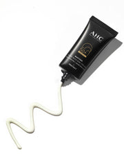 ProtoClinical k-beauty AHC Masters Aqua Rich Sun Cream 50ml (SPF50+/PA++++) single upright dark sun cream package centered on a light background with soft gray side shadows.