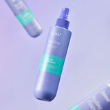 ProtoClinical k-beauty tall blue skincare product on a light cream background.