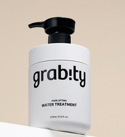 ProtoClinical k-beauty grabity Hair Lifting Water Treatment 270ml single upright pale blue treatment bottle with a dark cap centered on a warm beige background.