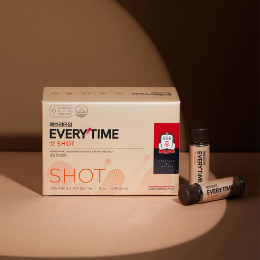 ProtoClinical k-beauty beige beauty product packaging on a dark brown background.