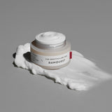 ProtoClinical k-beauty warm gray beauty product silhouette with a soft pale vertical form on a dark background.