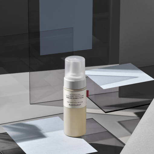ProtoClinical k-beauty dark charcoal beauty detail with pale vertical forms on a muted background.