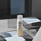 ProtoClinical k-beauty dark charcoal beauty detail with pale vertical forms on a muted background.