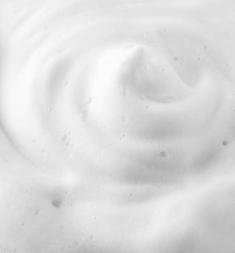 ProtoClinical k-beauty pale cream beauty detail with a soft taupe lower-right form on a light background.