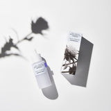 ProtoClinical k-beauty pale lavender beauty detail with a dark taupe vertical center on a light background.
