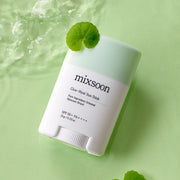 ProtoClinical k-beauty muted green beauty product silhouette with a pale beige center on a light background.