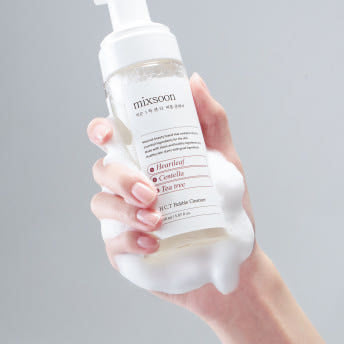 ProtoClinical k-beauty soft warm beige beauty product silhouette on a muted blue-gray background.