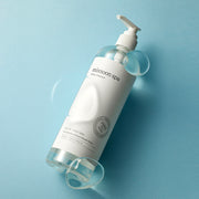 ProtoClinical k-beauty pale blue and cream product packaging with a dark teal lower section on a light background.