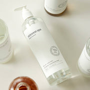 ProtoClinical k-beauty pale green and beige product packaging with soft peach lower accents on a light background.