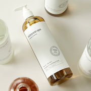 ProtoClinical k-beauty pale green and beige product packaging with soft peach lower accents on a light background.