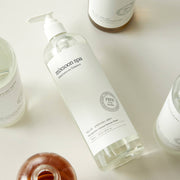ProtoClinical k-beauty pale green and beige product packaging with soft peach lower accents on a light background.