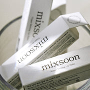 ProtoClinical k-beauty mixsoon Vegan Melting Lip Balm 4.1g single pale lip balm silhouette centered upright on a white background with dark gray top and base accents