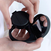 ProtoClinical k-beauty dark rounded beauty product silhouette with pale side accents on a light background.