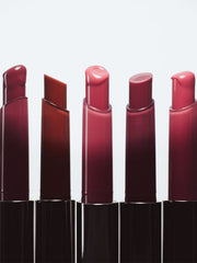 ProtoClinical k-beauty NAMING Syrup Melting Stick 1.7g (8color) single upright lip stick case centered on a pale background