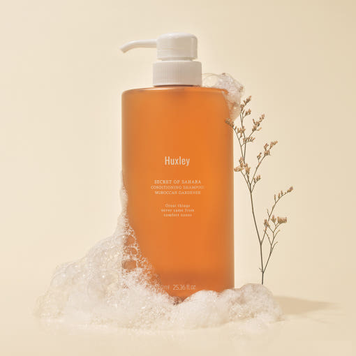 ProtoClinical k-beauty warm beige beauty product silhouette with a dark caramel center on a pale blue and cream background.