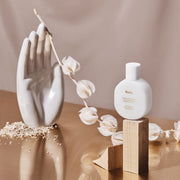 ProtoClinical k-beauty Huxley Hand Refresher 55ml #Berber Portrait with peach, olive, and cream packaging forms on a pale background