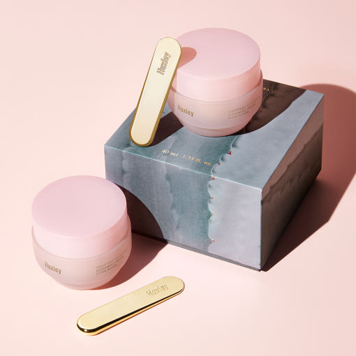 ProtoClinical k-beauty two dark beauty product silhouettes on a soft peach background.