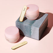 ProtoClinical k-beauty two dark beauty product silhouettes on a soft peach background.