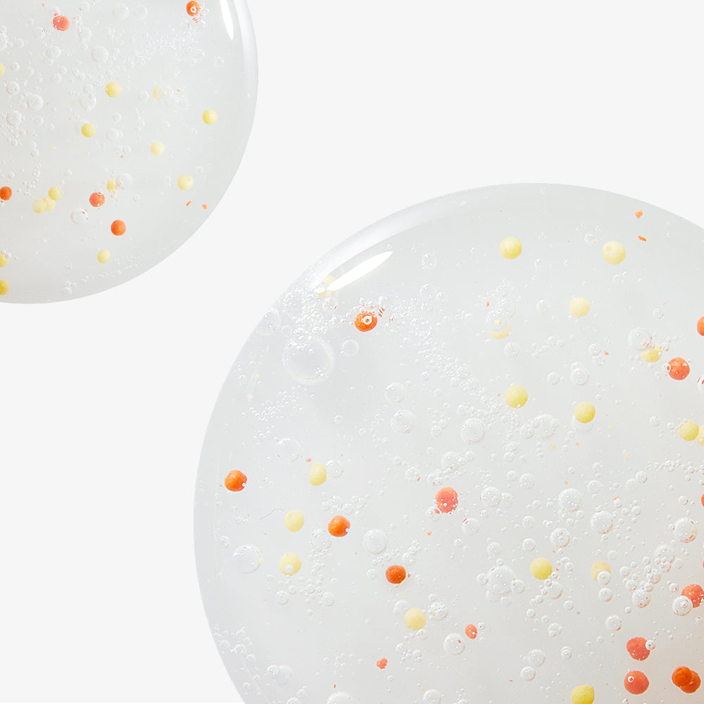 ProtoClinical k-beauty NEOGEN Dermalogy Double Vita Capsule Cleansing Foam 160g shown as translucent gel bubbles with yellow and orange capsule beads on a white background