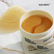 ProtoClinical k-beauty NEOGEN SUR.MEDIC+ Perfection 100TM 24K Gold Eye Patch 75g/60ea open white eye patch jar filled with gold hydrogel patches beside one loose translucent patch on a white marbled background