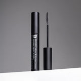 ProtoClinical k-beauty Benton Honest Black Eyelash Serum 8ml model portrait holding the black eyelash serum tube against a soft gray background