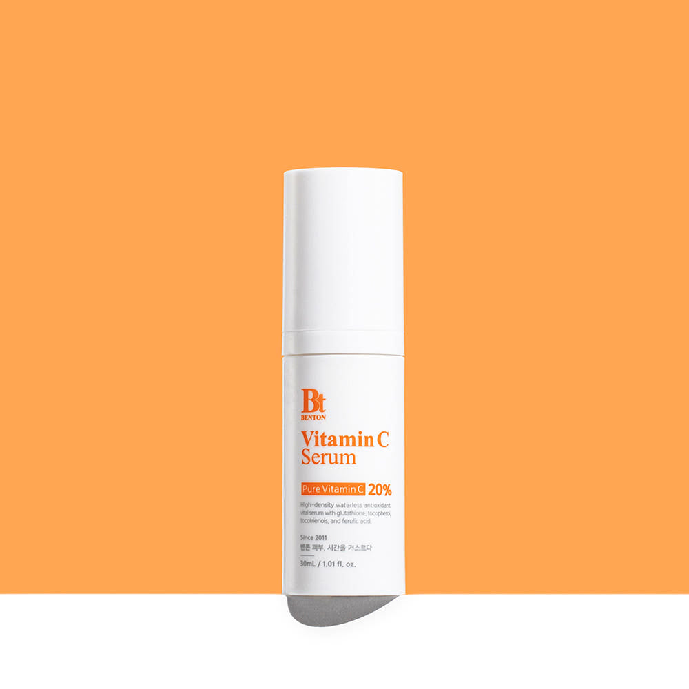 ProtoClinical k-beauty Benton Vitamin C Serum 30ml single upright pale beige serum bottle centered on a warm orange background with a soft cream base fade