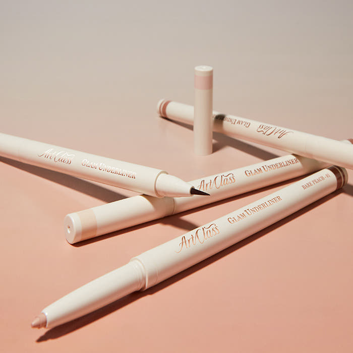 ProtoClinical k-beauty [TOO COOL FOR SCHOOL] Artclass Glam Under Liner 0.2g/0.7g (4 Colors) five cream liner pens layered diagonally on a peach background with one beige pencil tip and one fine brush tip exposed