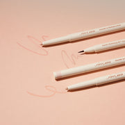 ProtoClinical k-beauty [TOO COOL FOR SCHOOL] Artclass Glam Under Liner 0.2g/0.7g (4 Colors) four cream liner pens laid diagonally on a peach background with one fine brush tip, two beige pencil tips, and soft swatch marks