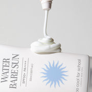 ProtoClinical k-beauty [TOO COOL FOR SCHOOL] Water Bare Sun SPF50+PA++++ 50ml close-up of a white tube dispensing cream beside a blue sunburst label on a pale background