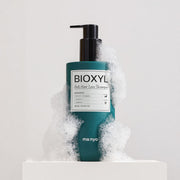 ProtoClinical k-beauty muted green beauty product silhouette with pale side panels on a light background.