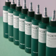 ProtoClinical k-beauty [MANYO FACTORY] BIOXYL Anti-Hair Loss Treatment 200ml with a deep green and charcoal graphic, bright diagonal bands, and darker lower shading on a light background