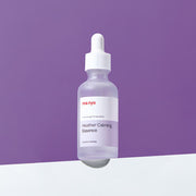 ProtoClinical k-beauty [MANYO FACTORY] Heather Calming Essence 50ml shown as an abstract purple graphic panel with a soft central highlight and darker lower shading on a light background.