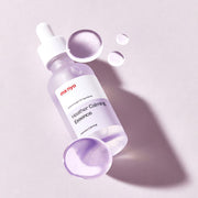 ProtoClinical k-beauty [MANYO FACTORY] Heather Calming Essence 50ml shown as an abstract pale lavender graphic panel with a soft gray vertical accent and darker lower bands on a light background.