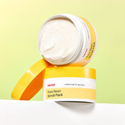 ProtoClinical k-beauty [MANYO FACTORY] Pure Bean Scrub Pack 100g single centered warm beige scrub pack container on a white background with pale yellow upper accents.
