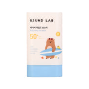 ProtoClinical k-beauty Round Lab Baby Mild Sun Stick 21g (SPF50+ PA++++) single upright beige sun stick container on a white background with soft blue lower corners.