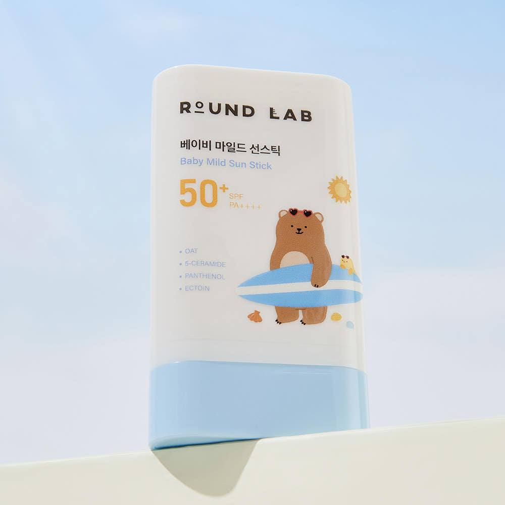 ProtoClinical k-beauty Round Lab Baby Mild Sun Stick 21g (SPF50+ PA++++) single upright beige sun stick container on a white background with soft blue lower corners.