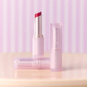 ProtoClinical k-beauty peripera Ink Mood Glowy Balm 3.4g rose-gold lip balm tube with an open red balm bullet and glossy red swatches on a white background