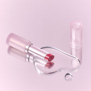 ProtoClinical k-beauty peripera Ink Mood Glowy Balm 3.4g pink lip balm tube with an open berry balm bullet and rosy swatches on a white background