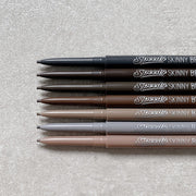 ProtoClinical k-beauty PERIPERA Speedy Skinny Brow 0.05g (#8~#10) single dark brow pencil standing upright on a light neutral background