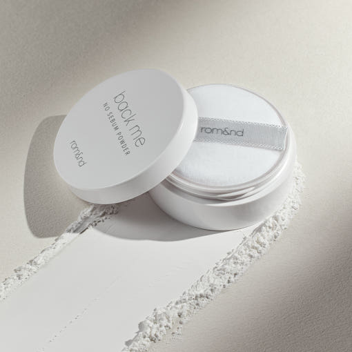 ProtoClinical k-beauty rom&nd Back Me No Sebum Powder 5g shown as a single pale gray powder package centered on a light background
