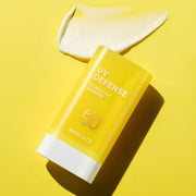 ProtoClinical k-beauty BANILA CO UV Defense Waterproof Sun Stick SPF50+ PA++++ 18.5g single upright yellow sun stick package centered on a bright yellow background with soft white side accents.