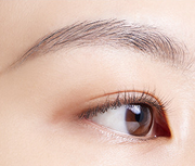 ProtoClinical k-beauty BANILA CO Smudge Out Detail Browcara 4g single slim brown browcara tube centered on a pale beige background with soft side shading