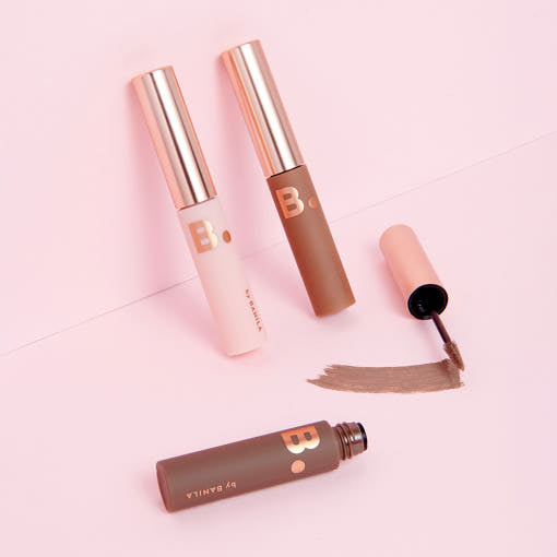 ProtoClinical k-beauty BANILA CO Smudge Out Detail Browcara 4g single slim brown browcara tube centered on a pale mint and cream background