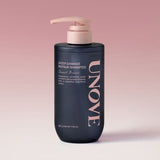 ProtoClinical k-beauty UNOVE DEEP DAMAGE REPAIR SHAMPOO 500ml #Sweet Breeze single upright dark shampoo bottle centered on a soft pink background.