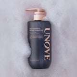ProtoClinical k-beauty UNOVE DEEP DAMAGE REPAIR SHAMPOO 500ml #Sweet Breeze single upright dark shampoo bottle centered on a soft pink background.